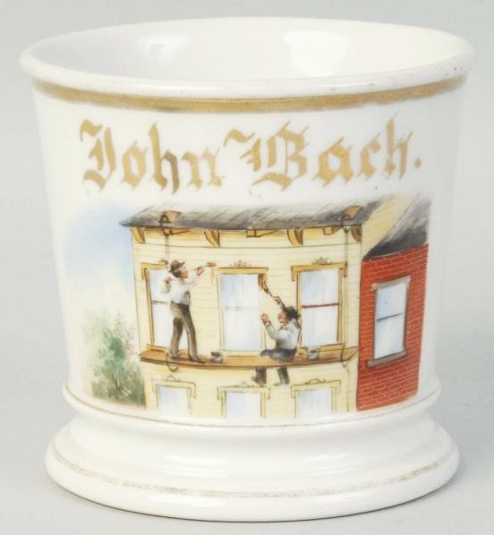 House Painter on A Swinging Scaffold Shaving Mug.: Depicts painters on a swinging scaffold painting the front of a building. Marked John Bach. Stamped in green GDA over France. No cracks chips or repairs. Medium loss of gold on both the top and bottom