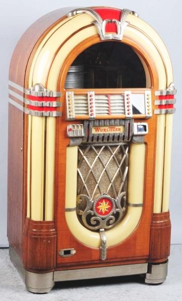Wurlitzer 1015 Juke Box.: Has coin equipment and converted with gears to play 45 rpm records. Old restoration to very solid original. Not playing but appears completely except for one caster and one tune card holder. Condition