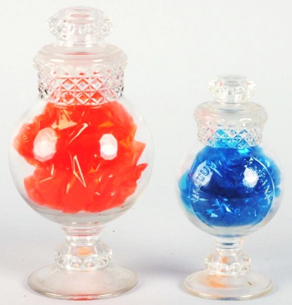Lot of 2: Dakota Globe Candy Jars.: Both ground. One - Eight inches. No cloudiness or scratches and no chips. Second is six inches tall with vacuum country advertisement. No chips or damages or cloudiness. Condition (Excellent). Size La