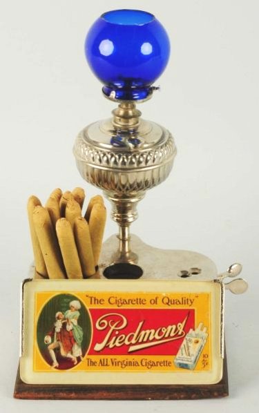 Piedmont Cigar Cutter & Lighter.: Nice original working condition. Has image of man smoking a piedmont cigarette. Condition (Excellent). Size 13" T.