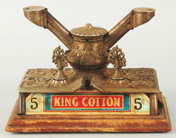 King Cotton Cigar Cutter.: On an oak base. Works. Some minor pitting. Condition (Very Good - Excellent). Size 10" L.