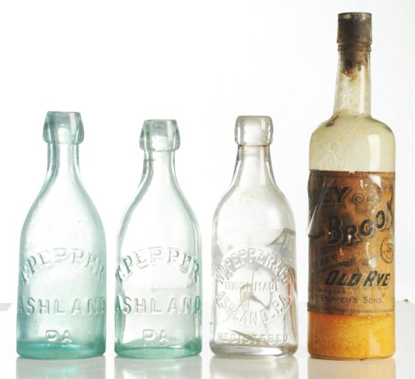 Lot of 4: Asst. Wm. Pepper Related Early Bottles.: One whiskey with partial paper label and three soda bottles One soda has extensive closed cracks, the others lighter wear. Condition (Fair - Near Mint). Size Largest: 10" T.