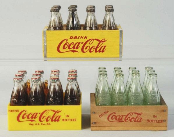 Lot of 3: Coca-Cola Miniature 12 Packs.: 1950s-60s, with two made of wood, one plastic. Only the bottles in the largest carrier show wear in the form of lost interior paint, or fluid in a few instances. Condition (Excellent - Near Mint). Siz