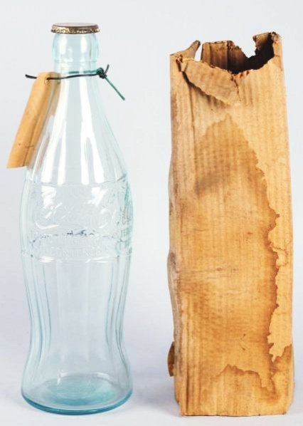 1930s Coca-Cola Display Bottle.: Comes with a weathered box sleeve and its original instruction tag for filling original cap has minor marks and edge wear, the bottle is clean. Condition (Excellent). Size 20 - 3/4" T.