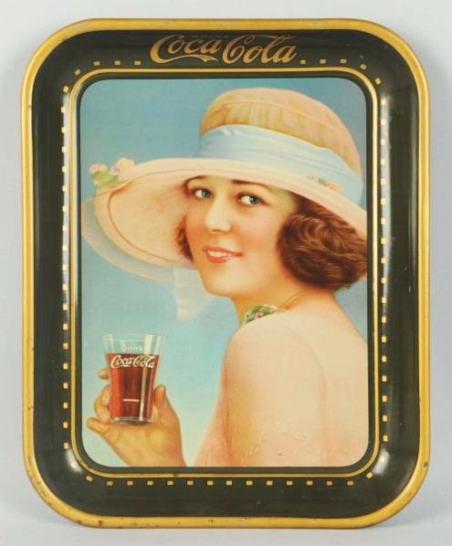 1922 Coca-Cola Serving Tray.: Strong example. Small scratch near her thumb and minimal rim nicks. Condition (Excellent). Size 13 - 1/4" x 10 - 1/2".