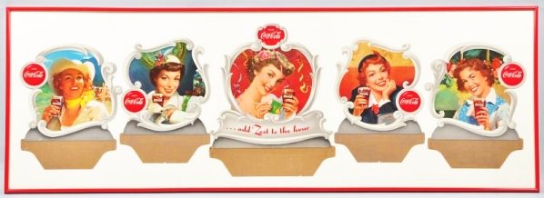 1951 Coca-Cola Girls’ Heads Festoon.: Framed under plexi. Mild to medium bends on most pieces and a short closed tear to two, with other minor marks. Small stain and ripples on lower left of center element. All this only impacts display a