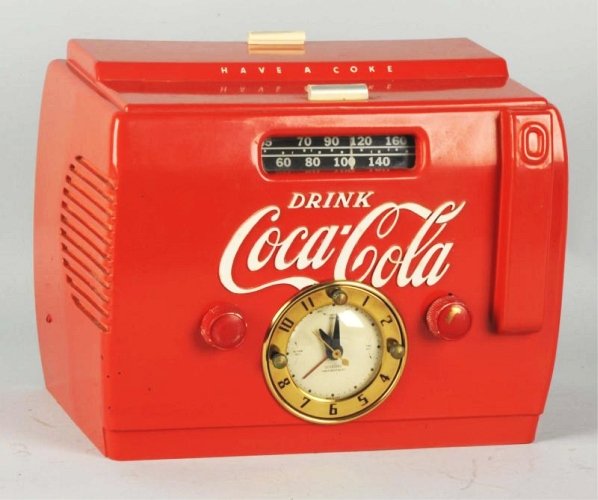 1950's Coca-Cola Cooler Clock Radio.: Nice example with complementing non-original knobs. Case is strong and clean with a few tiny nicks and color rubbing on top lift handles. Condition (Excellent - Near Mint). Size 12" L.