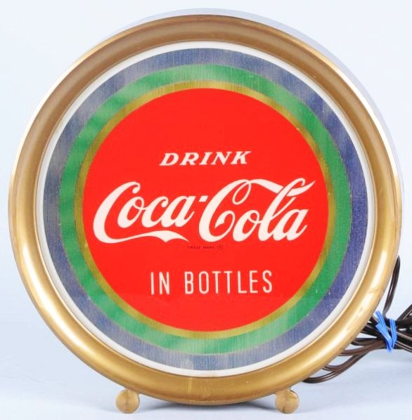 1950's Coca-Cola Countertop Lit Sign.: When you move it simulates a motion light. Small flake at bottom of lens center and rust on back metal case. Condition (Very Good). Size 11 - 1/2" T.