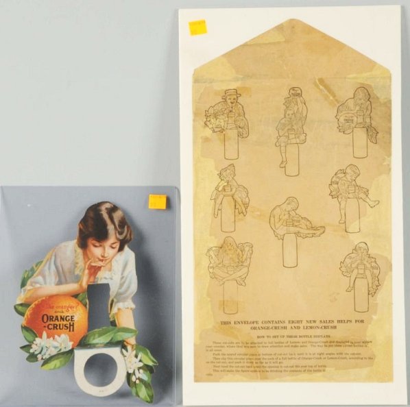 1920s Cutout Orange Crush Bottle Topper.: Complete with an envelope cover that once held this and seven other bottle displays. Instructions and paper infill on that. The topper is beautiful, with three old bend or tear lines with well-done co