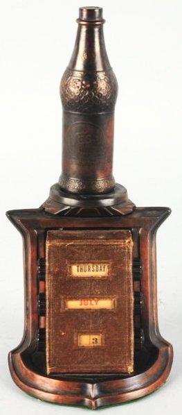 Vess Perpetual Desk Calendar.: 1930s-40s with a bottle topping the piece heavily made with moderate wear. Bottle rocks a bit as it is seated somewhat loosely. Condition (Very Good). Size 11" T.