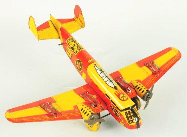 Marx Tin Litho Wind-up Airplane Toy.: Bomber type although it says TWA on both sides of rear tail fin. Includes four mounted guns and two metal props in front. Some scratching and wear to lithograph. Condition (Very Good - Excellent). Siz