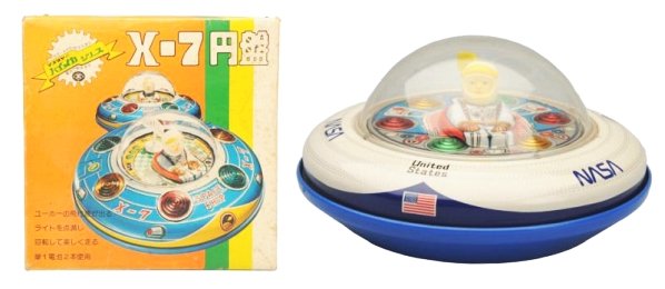 Tin Litho & Plastic Batter Op. NASA Spaceship.: Made in Japan by Masudaya. Has box. Depicts a saucer that is a bit different than the one here. Box has small tears and darkening due to age. Toy (Near Mint). Box (Excellent). Size 8 - 1/4" Dia.