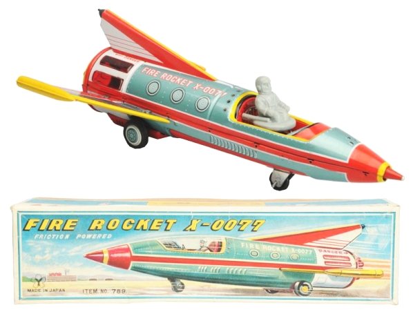 Tin Litho Friction Fire Rocket X-0077.: Made in Japan by Yonezawa. Working. Original box. Box has some tear repairs to the face and one small puncture. Toy (Near Mint). Box (Excellent). Size 14 - 1/2" L.