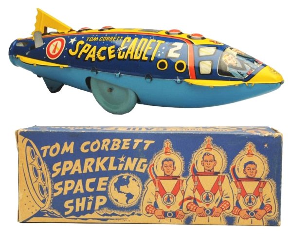 Tin Litho Wind-up Tom Corbett Sparkling SpcShip.: Made in USA by Marx. Box has some darkening with age. Some edge wear and some wear on the end flaps. Toy (Near Mint). Box (Excellent). Size 12" L.