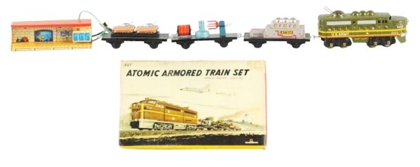 Scarce Japanese Battery Op. Atomic Armored Set.: Includes original box. Box has some staining and tearing; has cardboard inserts and track. Made by Bandai Japan. Set includes No.2373 U.S. Army locomotive, flat car with M-391 tanks, Atomic Power plan