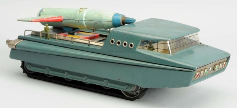 Tin Litho & Painted Battery Operated Vehicle.: Made in Japan. It is a Sears Exclusive toy. Working. No box. Has been married together with a rocket from another toy so it is incomplete and has a piece that does not go to it. Several areas of crazi