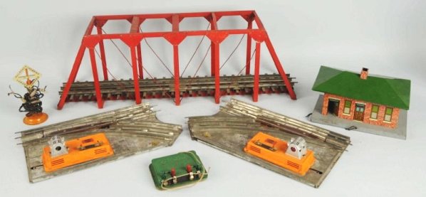 Lot of 3: American Flyer Train Accessories.: Wide gauge. All have original boxes. A No.4488 pair of remote controlled track switches, a No.96 station and there is a large wooden bridge. Some tape to station box. All have general wear. Condition 
