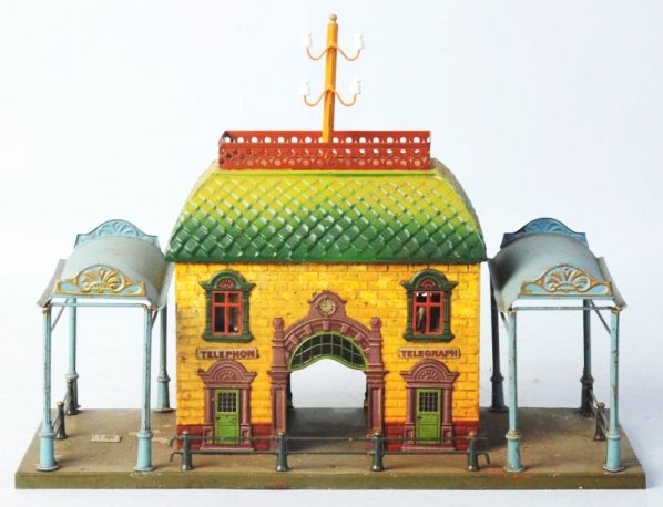 German Bing 1Gauge Telegraph Train Station.: Base has been drilled to attach to a platform. Has the BW Bavaria plate on base. Two awnings looks to be all original except for top telegraph pole. Some crazing and rubbing to paint. Some paint flaki