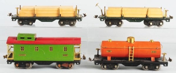 Lot of 4: Lionel 500 Series Freight Cars.: Standard gauge. Includes No.515 tank car in taracota. No.517 caboose and two No.511 lumber cars with wooden loads. Some scratching and wear mostly to roofs. Condition (Very Good).