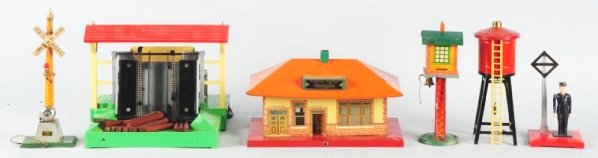Large Lot of American Flyer Train Accessories.: Includes Lumber Loader, S Gauge Newsstand, Two pre-war tin stations, Water tower and several crossing signals and other items. Condition (Very Good).