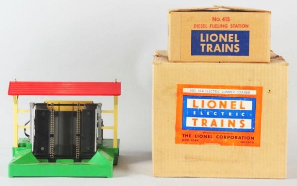 Lot of 2: Lionel Post War Accessories.: Both original boxes. No.164 Lumber loader electric, and a No.415 Diesel Fueling station. Lumber loader box has some creasing to top of box. Diesel fueling station looks virtually unused. Condition (Ex