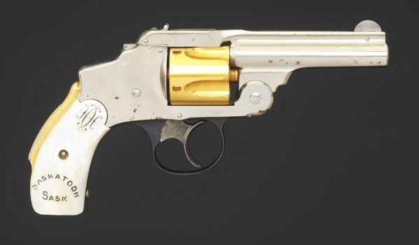 Smith and Wesson .38 cal. Hammerless Revolver**.: Smith & Wesson Model 2 hammerless revolver in .38 cal. in very good condition with nickel finish, pearl grips marked Saskatoon, fluted gold cylinder and back strap, and top latch. Overall length 7 1/2