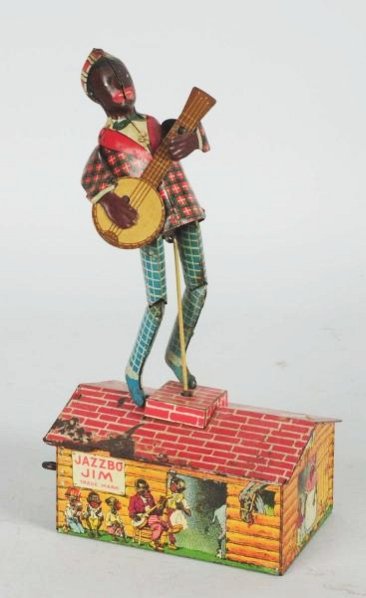 Strauss Tin Litho Wind-up Jazzbo Jim Figure.: Includes original arms and banjo. Some pitting and rust to piano. Some other general wear. Condition (Very Good). Size 9 - 1/4" T.