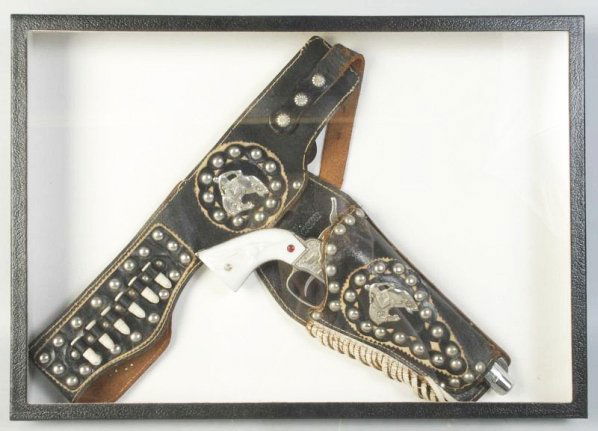 Nichols Mark 1 in Lone Ranger Holster.: One grip has a corner chip. Includes five bullets. Holster marked "Lone Ranger" on upper holster on the inside. Gun (Very Good - Excellent). Holster (Very Good). Size 12 - 1/2" L.