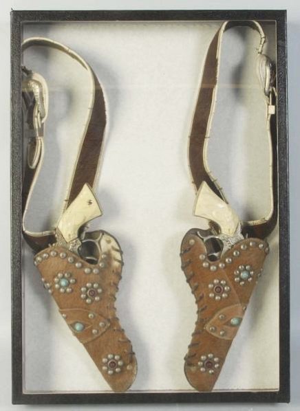 Gene Autry Double Gun & Holster Set.: One gun fired many caps. Other is unfired. Holster wear and vinyl cracking in numerous areas. Condition (Very Good Plus). Size Each: 9 - 1/2" L.