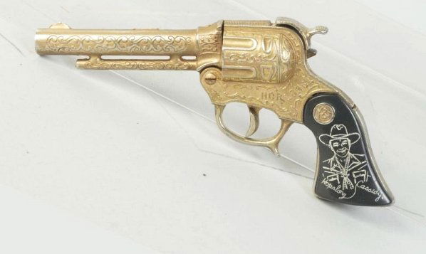 Hopalong Cassidy Cap Gun.: Gold finish has darkened and worn on all the high spots and fired caps. Condition (Very Good). Size 9 - 1/4" L.