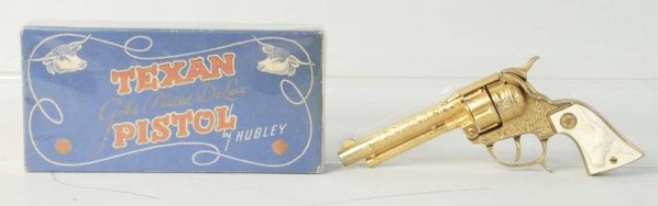 Hubley Gold Texan Cap Gun.: Gun has fired caps. Gold finish is nicer than most. Scuff on one grip. Two piece box. Gun (Excellent). Box (Very Good - Excellent). Size 10" L.