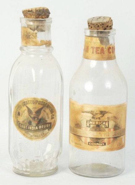 Lot of 2: Glass Product Jars.: Slightly darkened and soiled labels with wear. Size Largest: 8 - 3/4" T.