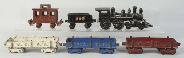 Cast Iron American Made Floor Train Set.: Includes American style engine with cow catcher with the side rods. Tender is embossed "999". Also includes three dump cars and a caboose marked "MCRR". Some scratching and paint loss especially to ca