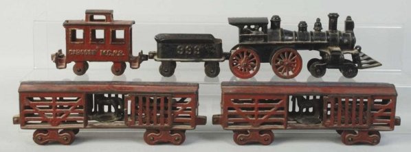 Cast Iron American Made Floor Train.: Frieght set includes american style engine with cow catcher. Embossed "49" on sides of cab. Embossed "999" on tender. Has two stock cars and one caboose marked "MCRR". Caboose has mold flaw on top of 