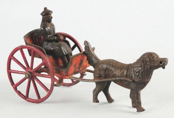 American Made Cast Iron Dog Pulling Cart.: Has original woman figure in cart. Looks like it has some repainting to the bottom of the cart. Condition (Very Good). Size 7 - 3/4" L.