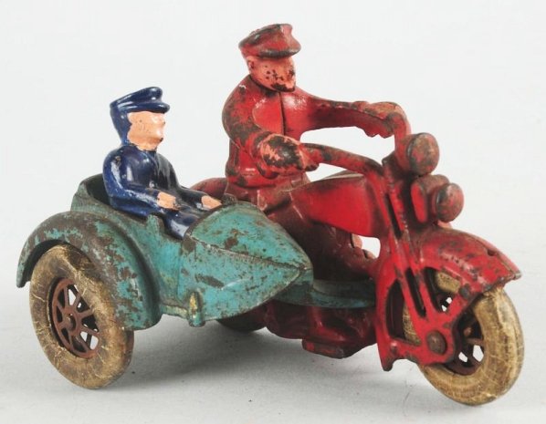 Cast Iron Hubley Harley Davidson Motorcycle.: Motorcycle has a sidecar. Includes replacement passenger. Has white rubber tires. Marked "Harley Davidson" on one side of gas tank. Some paint loss and wear throughout. Condition (Very Good). Size 5" 