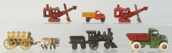 Misc. Lot of Vehicle Toys.: Cast iron, diecast, and slush mold. Inclues a Hubley dump truck, two small steam shovels, a tootsietoy stake back truck, a cast iron Victor engine and tender combination, and a slush mold Conestoga Wa