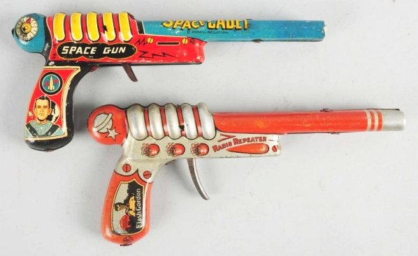 Lot of 2: Marx Tin Litho Space Ray Guns.: Includes a Tom Corbett Space Cadet and a Flash Gordon Radio Repeater. Both have scratching and wear. Well used. Condition (Very Good). Size Each: 10" L.