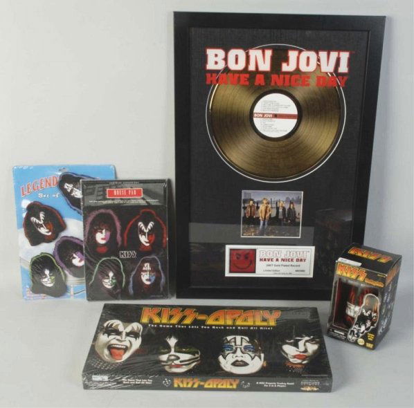 Lot of 5: Assorted Kiss & Bon Jovi Items.: Includes a KISS nesting doll set, a set of magnets, a mouse pad, and a board game. All are mint in package. Also included is a Bon Jovi souvenir gold record in frame. Condition (Excellent). Size Large