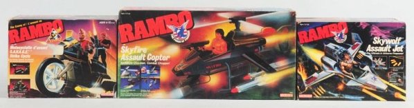 Lot of 3: Rambo Movie Vehicle.: All in original boxes. One is a Skyfire Assault Copter, Savage Strike Motorcycle, and a Skywolf Assault Jet. Some wear to boxes. Made by Coleco. Condition (Very Good - Excellent). Size Largest: 18" L.