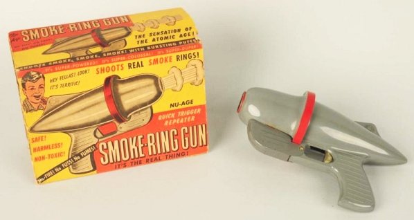 Vintage American Made Smoke Ring Gun.: Includes partial original box. Missing both sides of end flaps. Plastic. Circa 1950s. Does have some wear. Condition (Very Good). Size Box: 8 - 1/2" L.