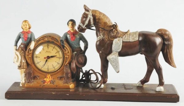 Vintage White Metal Western Themed Mantle Clock.: Looks like Roy Rogers and Dale Evans knock off. Unmarked. Shows horse man woman standing next to clock. Marked Oxford. Some overall wear. Condition (Very Good). Size 19 - 1/2" L.