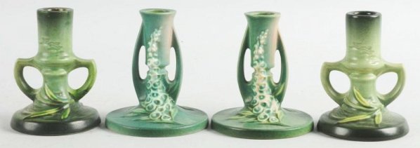 Lot of 4: Roseville Candlestick Holders.: Lillies of the Valley #1150. Bottom chip and 1161. No damage or repair. Condition (Excellent). Size Largest: 5" T.