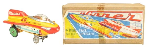 Japanese Tin Litho Winner Rocket Toy.: Battery operated. Includes original box with nice colorful label. Does have some tape on lid. Comes with original rubber track and box insert. Rocket marked 23 on both sides and Winner on back tail fi