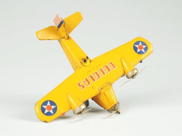 Japanese Tin Litho Wind-up Douglas Airplane Toy.: Pre-war. Marked "Made in Japan" on wing. Tri-motor plane with original props. Original tail fin marked "CK, Made in Japan". Some overall scratching and wear. Condition (Very Good). Size 9 - 3/4" Wings