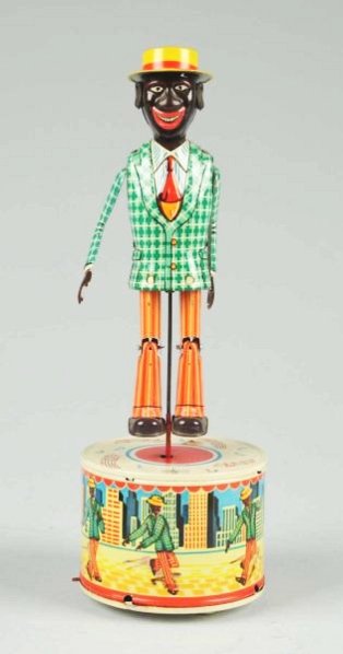 Japanese Tin Litho Batt. Op. Strutting Sam Toy.: Includes colorful original box. Marked "Made in Japan". Nice tin litho base. When in operation, figure dances. Has extremely hard to find rubber ears in tact. Box has some creasing and wear. Very litt