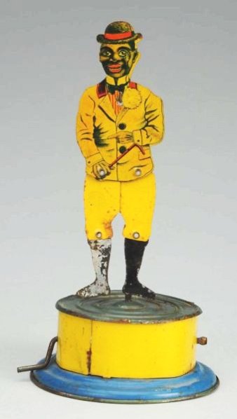 Tin Litho Dancing African American Toy.: American made. Unmarked. Scarce version and very seldom seen. When crank is turned, tin litho figure dances up and down on stand. Paint loss to right leg and some scratching and pitting around base. C
