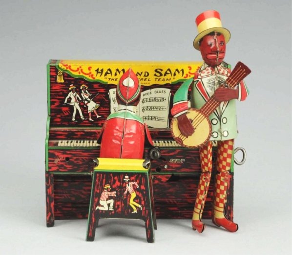 Tin Litho Ham & Strauss Team Wind-up Toy.: Toy has original arms on both figures. Toy has slight play wear and comes with original box. Box has a lot of creasing but complete. Size 7" L.