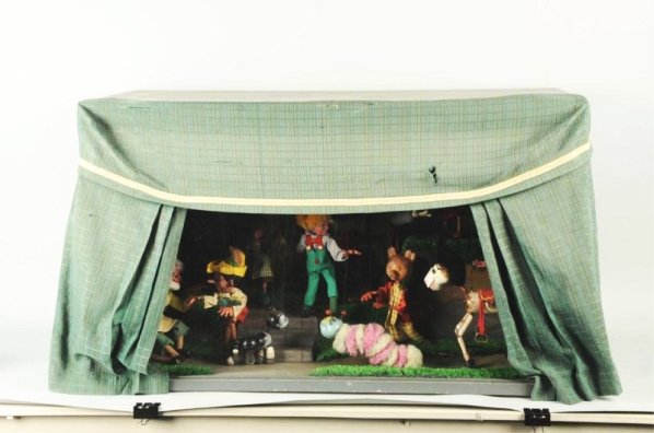 Very Unusual Pelham Walt Disney & Other Puppets.: In display shadow box. Well-made mechanical lit up. Has a nice back ground scene. Has Jepeto, Pinocchio, Figuro and other Disney characters. Wired in. Post war. Condition (Very Good - Excellent). Size