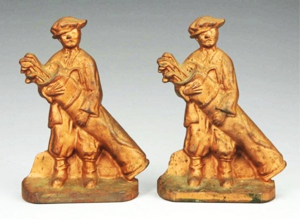 Cast Iron Caddie Doorstops Bookends.: Signed on front. Later casting. Condition (Excellent). Size Each: 8" T.